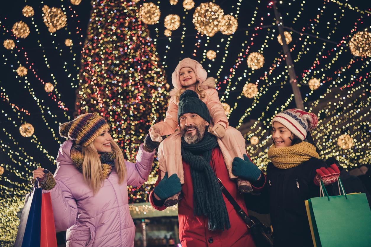 Famille en bonnets de Père Noël profitant de son voyage de Noël